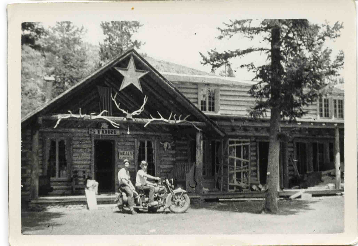 Shoshone Lodge photograph from the 1930s featuring two men on a motorbike in front of the lodge.